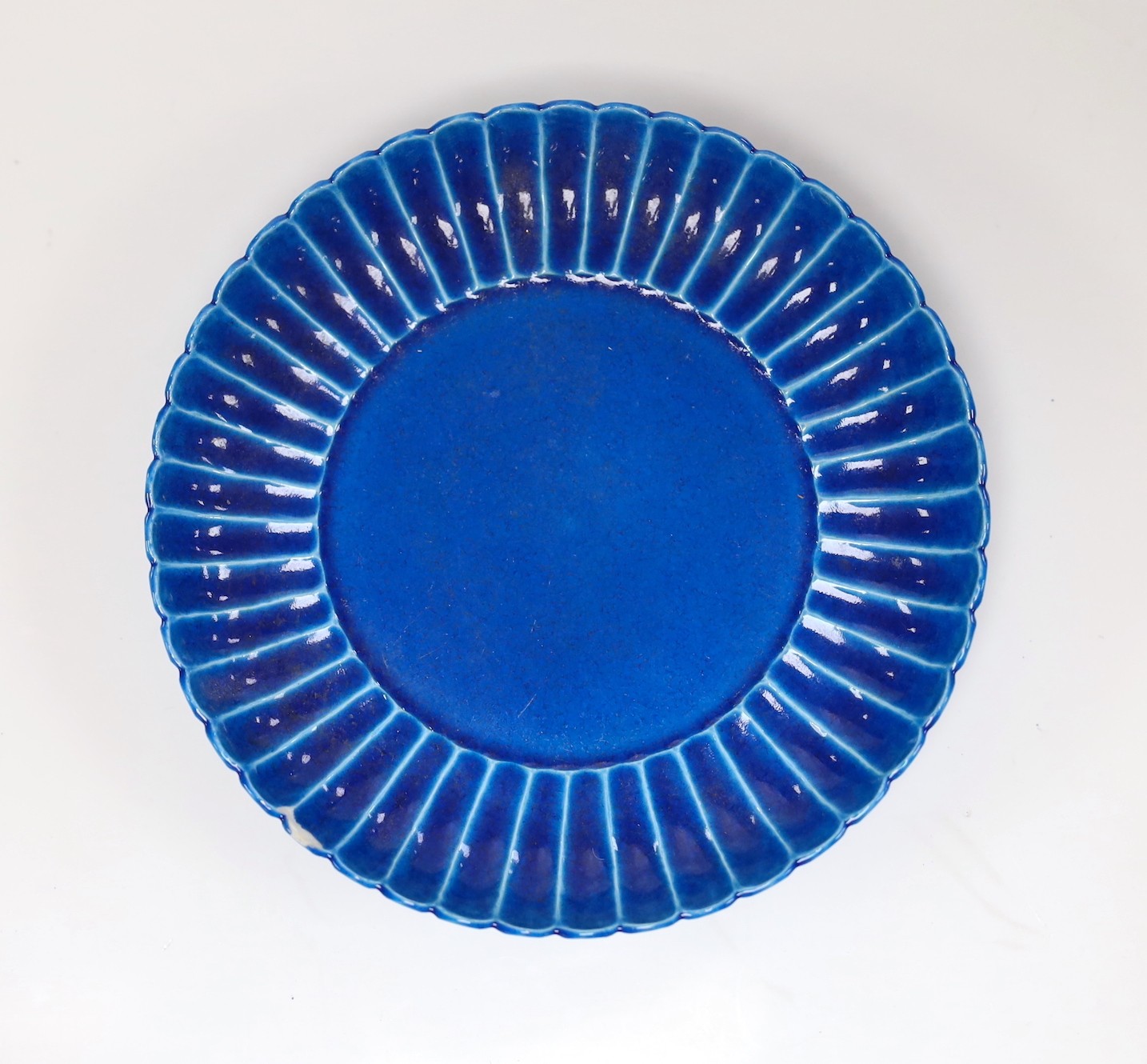 A Chinese blue monochrome earthenware dish, 15.5 cms diameter